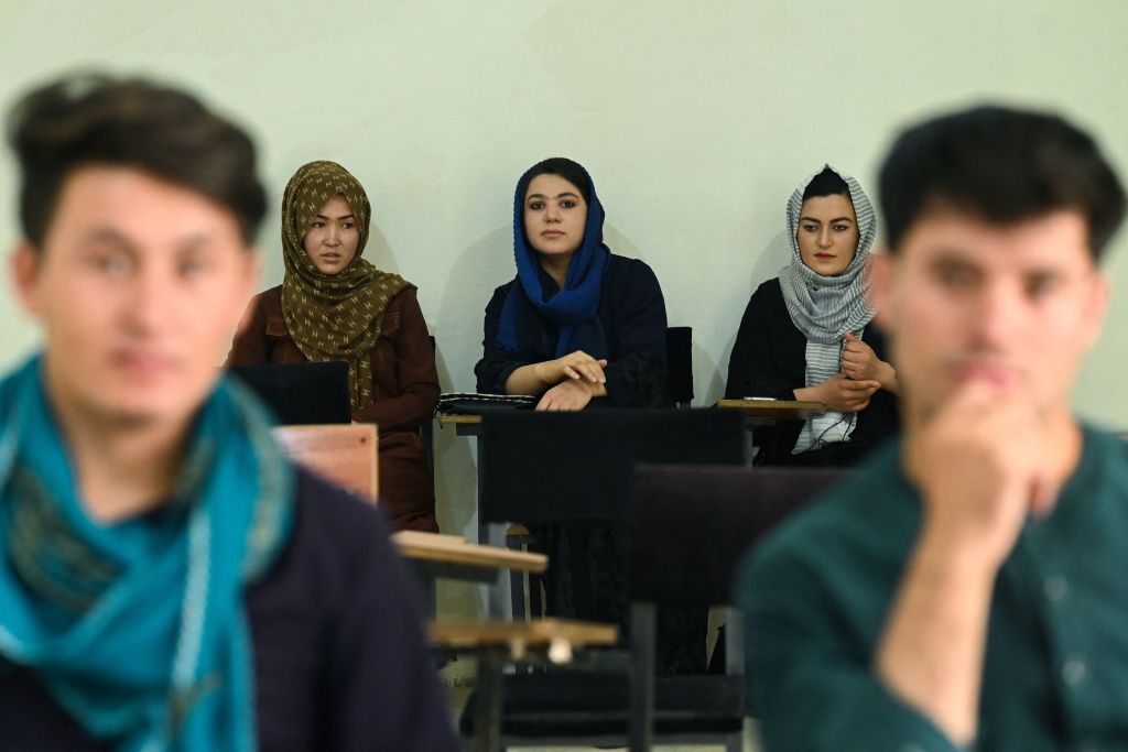 TOPSHOT - Students attend their class after private universities were reopened in Kabul on September 6, 2021. - Women attending private Afghan universities must wear an abaya robe and niqab covering most of the face, the Taliban have ordered, and classes must be segregated by sex -- or at least divided by a curtain. (Photo by Aamir QURESHI / AFP) (Photo by AAMIR QURESHI/AFP via Getty Images)