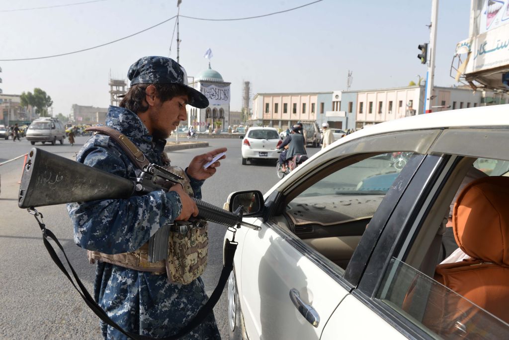 A member of Taliban checks a document of a driver at a security checkpoint in Kandahar city, Afghanistan, Sept.11,2021. (Photo by Sanaullah Seiam/Xinhua via Getty Images)